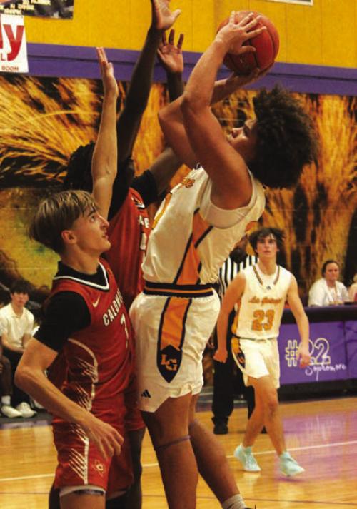 La Grange’s Devonte McKenzie goes to the basket as two Caldwell players defend on the play Friday. Photo by Jeff Wick