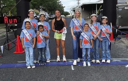 Fastest female Jaylee Grifaldo, of Flatonia, is pictured with members of the Schulenburg Festival Royalty.