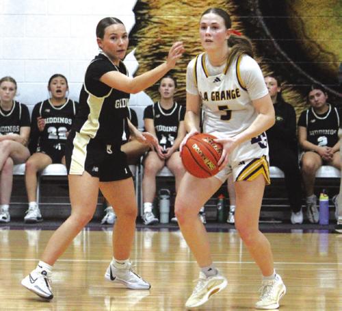 La Grange’s Campbell Cooper, right, looks to make a pass in Tuesday’s game. She scored a team-high 21 points. Photo by Jeff Wick