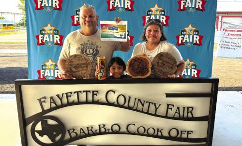 Jason and Nicole Vasut, and Nicole’s daughter Reeanna Ramirez front, showing off their wins at the Fayette Co. Fair BBQ Cookoff. Reeanna will also be competing in Houston in the Kids Cookoff. This will be the first time for Fayette County to have a kid compete at nationals.