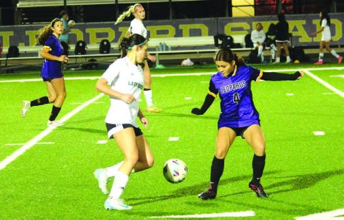 La Grange’s Miriam Lopez, right, tries to block the advance of this Taylor player Tuesday. Photos by Jeff Wick