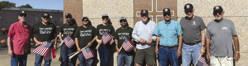 Volunteers from Invenergy assisted American Legion Post 143 of Schulenburg to place flags on the graves of deceased veterans ahead of Memorial Day.