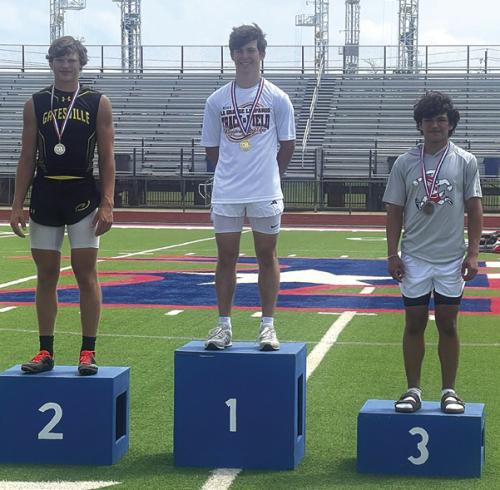 La Grange’s Cordale Knapik stands atop the medal stand in Bullard after winning the regional pole vault title Friday.
