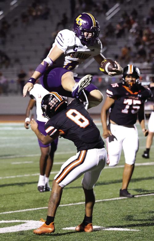 La Grange quarterback Clayton Cooper made the play of the year so far for the Leps as he hurdled this would-be Smithville tackler in Friday’s 52-7 victory Lots more on the big win in Section B today. Photo by Katy Michalke