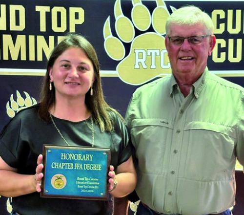 Round Top Carmine Education Foundation Board of Directors, Jackie Sacks and Ronny Sacks, accepting the Honorary Chapter FFA Degree.