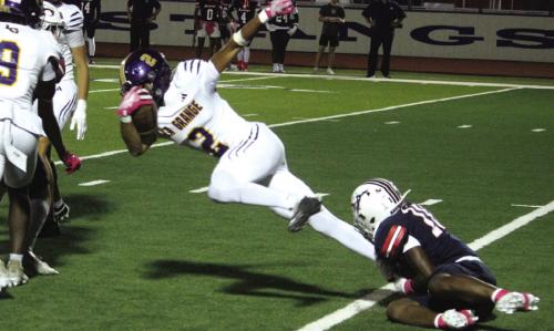 La Grange’s Dwodney Thompson tries to get free from a tackler Friday. Thompson had a huge game, scoring three touchdowns. Photo by Jeff Wick