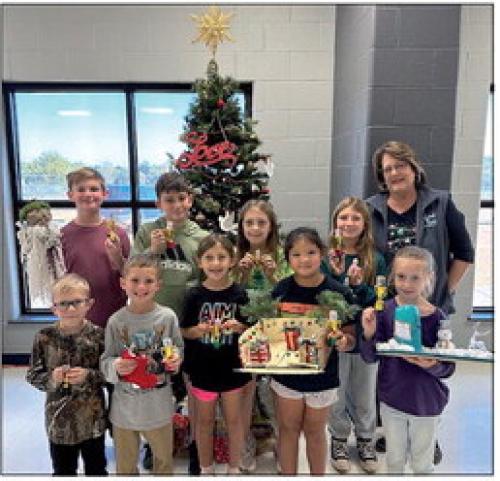 Creativity is being rewarded as these RTC students and two more were given an award for their home-made craft contest entries at the 40th Carmine Chamber of Commerce Christmas Fest on Dec. 1. Pictured are Levi Tuttle, Bowen Williams, Pyper Albrecht, Charlee Wischnewsky, Blake Bridges, Hutch Wischnewsky, Ppheya Albrecht, Maria LeBouef, Finley Martin. Not pictured are Rowdy Richards and Morgan Williams. Marlene Waak is the Chamber representative.