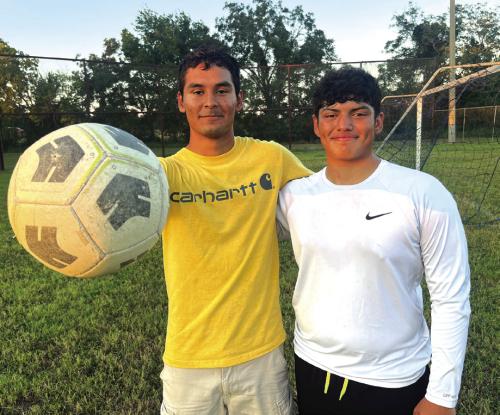 La Grange High School seniors Ramon Ortiz, left, and Matthew Olvera, right, are exhausted but still all smiles Tuesday evening after a full day of classes, followed by football practice, followed by leading a practice of their Optimist Club youth soccer team. Photo by Jeff Wick