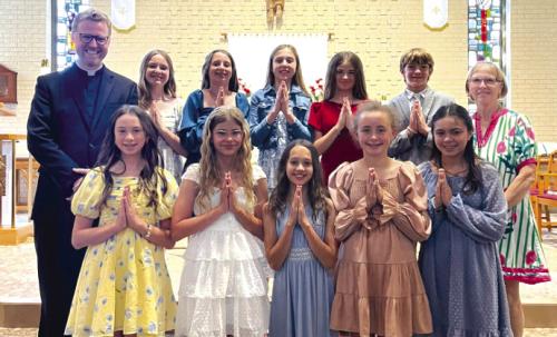Class of 2026 - 6th Grade Graduates, front from left: Krislee Kallus, Marley Vasek, Sophie Janda, Emmy Neal, Ellery Bradford; back row: Fr. Chris Smith (Pastor, Sacred Heart Catholic Church and School), Helen Streiff, Adalyn Emmel, Hallie Gross, Chezni Berdoll, Ricky Greenwood, Ms. Cathy Zingelmann (6th Grade teacher).