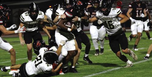 Schulenburg’s DaTerrion Houston carries several Rogers players with him as he runs the ball Friday. Houston rushed for a team-high 142 yards for the Shorthorns. Photo by Audrey Kristynik