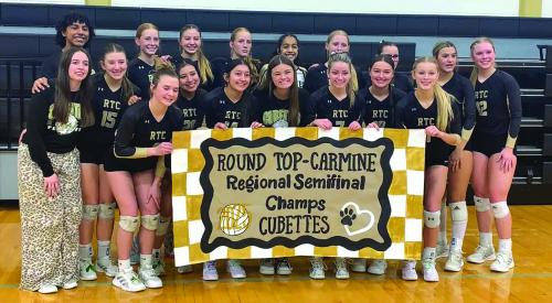 The members of the Round Top-Carmine volleyball team celebrate their victory Tuesday over Utopia in Seguin.