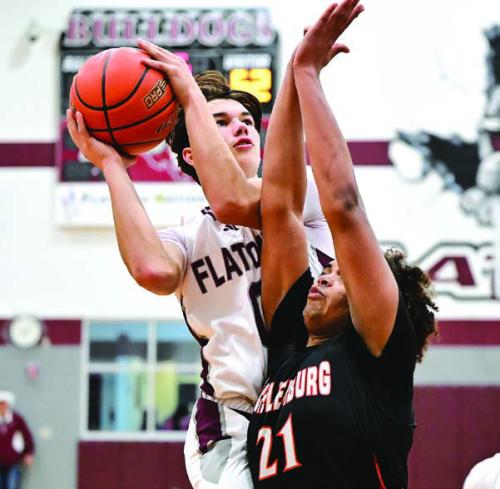 Flatonia’s Beck Zimmerman drives to the basket against the defense of Schulenburg’s Jayvan Luhrs Tuesday. Photo by Stephanie Steinhauser