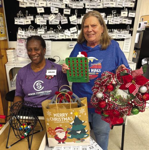 Annette Jasek (right) was the grand winner in Schulenburg for the bingo game. Not only did she win the blackout prize, a beautiful wreath made by Martha Beckmann. She also won a bag of holiday goodies for the big picture frame. Darlene Williams (left) called the game.