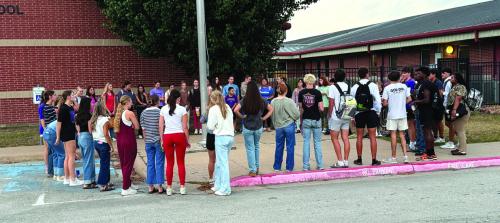 Wednesday several La Grange High School students attended the student-led Meet Me At The Pole prayer event before school. “It was the biggest turnout I had seen for years, with about 40 students attending, from all high school grades,” one teacher said. Junior Macie Collier led the students in prayers and read scripture and some other students led the group in prayer too. Photo by Deandra Baker