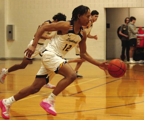 La Grange’s Jhase Scott leads a fast break in Tuesday’s victory over Smithville. Photos by Jeff Wick