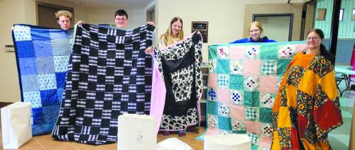 The Sewing Circle at Holy Cross presented quilts to each of the high school graduates that are members of the congregation. Pictured with their quilts are Donovan Phillips, Mason Messer, Layna Woelfel, Elena Matus, Emmerson Burton.