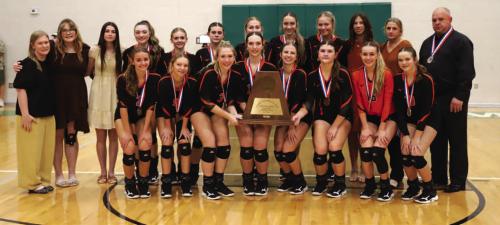 With state bronze medals around their necks, the members of the Schulenburg volleyball team pose with their state semi. nal trophy after falling in Saturday's match to Jewett Leon. Photo by Audrey Kristynik