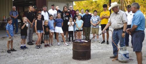 American Legion Post #338 with assistance for Carmine 4H students dispose of an American Flag as part of the Flag Disposal Ceremony held in association with the Carmine Chamber of Commerce Night Out on Oct. 2.