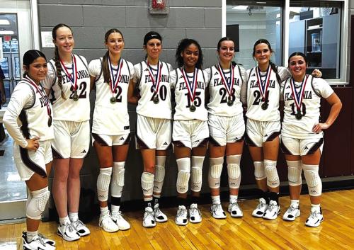 The members of the Flatonia girls basketball team pose with their championship medals after winning their home tournament Saturday.