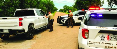 Fayette County Sheriff’s deputies blocked Old Plum Highway ahead of the scene of Wednesday’s fatal shooting. Photo by Andy Behlen