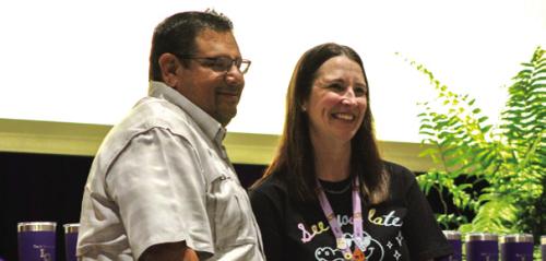 Kelli Tavarez, right, a teacher at La Grange elementary school, received $1,000 from Curt Harbers of Whataburger, right, for winning the What-a-Teacher Award, presented at Friday’s End of Year Convocation. Photo by Meadow Taylor-Marklin