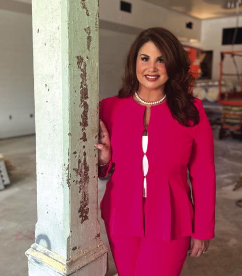 Newly appointed Executive Director Dr. Crystal Gully, in the soon to be completed Phase I of the Fayetteville Community Center &amp; Performance Theater, stands next to one of the reused columns from the original E.J. Knesek Building.