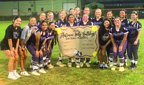 The members of the Flatonia softball team celebrate after Friday’s bi-district victory.