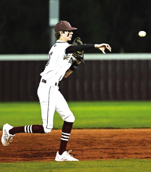 Blake Kessler throws back Henri Vincik at first to keep runner from advancing to second base. The Bulldogs defeated Bloomington Tuesday night in Flatonia. Photo by Stephanie Steinhauser