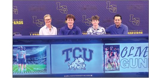 La Grange’s Oliver Gunn, second from left, is shown here at his signing ceremony Wednesday, as he inked a deal to play college football for TCU. Left is his mother Mary Gunn. Second from right is Oliver’s younger brother Shepherd and far right is his father Seth Gunn. Photo by Jeff Wick