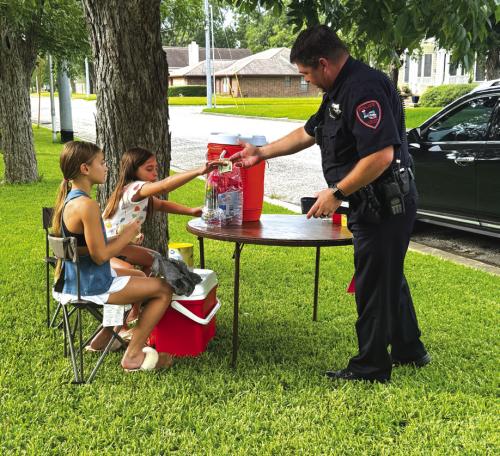 Girls Raise Money for Flood Victims at Lemonade Stand