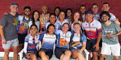 The 18 University of Texas riders in front of the Red &amp; White Inn and Gallery.