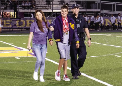 La Grange High School awarded Special Olympics athlete Dylan Haynie with a letterman jacket before the football game Friday night. Haynie competes in bowling and track and field. He is pictured here with his parents Jennifer and Steven Haynie. Photo by Andy Behlen
