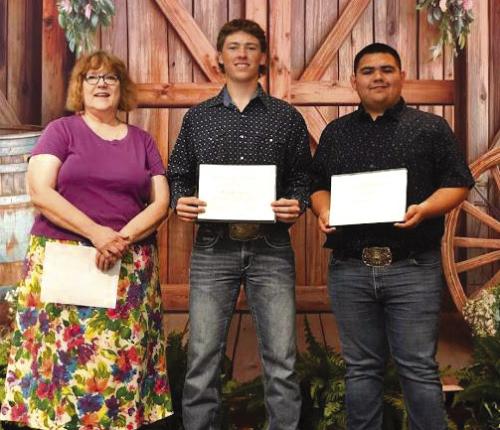 Weimar High School students Troy Cantwell (middle) and Ruben Garcia (right) receive the Friends of KBMH scholarship award for 2025-2026, presented by Katy Beauford (left).