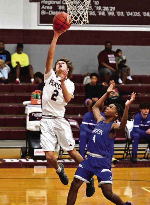 Kade Giese lays up a basketball for Flatonia in Monday’s basketball game against Snook. Photo by Stephanie Steinhauser