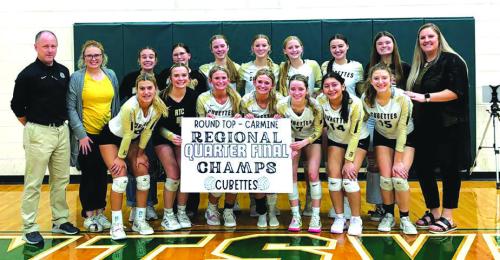 The members of the Round Top-Carmine volleyball team celebrate Tuesday’s third round playoff victory in Hunstville.