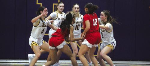 Left to right, La Grange’s Macie Collier, Avery Griffin, Kylie Trlicek and Campbell Cooper converge on this Cornerstone drive to the basket in Friday’s game. Photo by Jeff Wick