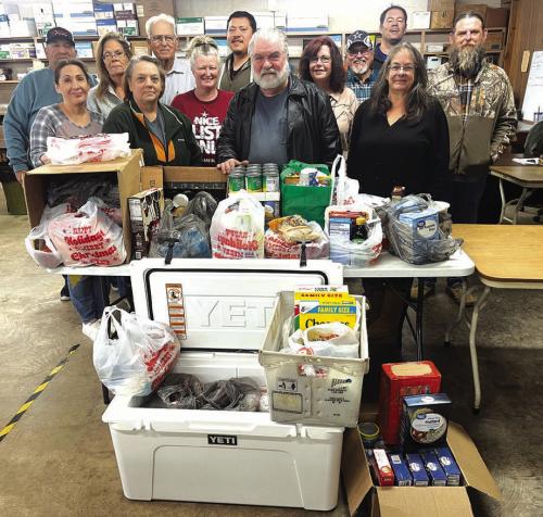 Staff members of The Fayette County Record with their donation to the AMEN Food Pantry – left to right: Jesse Montez, Theresia Keilers, Lou Ann Adcox, Sandra Boehm, George Kana, Becky Weise, John Castaneda, Bobby Bedient, Tammy Browning, Larry Pietsch, Jeff Wick, Debbie Matula, and Andy Behlen. Photo by H,H. Howze