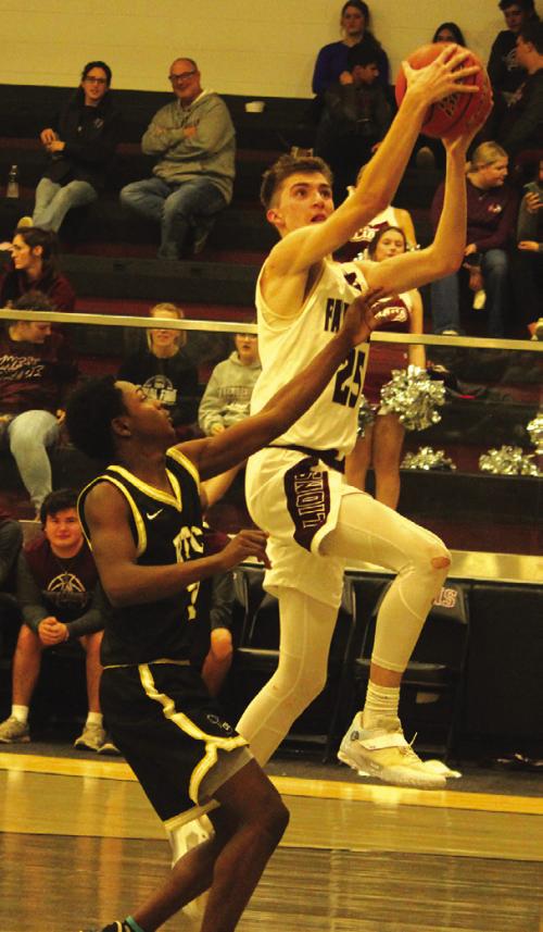 Fayetteville’s Easton Jaeger drives to the basket against the defense of Round Top-Carmine’s Tre’Veon Fischer. Jaeger had a team-high 17 points Friday. Photo by Jeff Wick