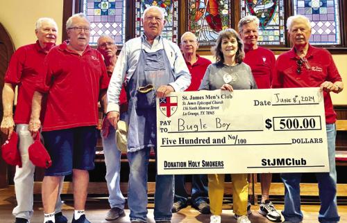 The St. James Men’s Club Holy Smokers recently cooked for the Bugle Boy. Pictured (from left) are Tom Tracy, Jim Malik, Paul Cheatham, Ed Dykes, Ernie Balla, Bugle Boy Executive Director Heather Allbright, John McLean and Dan Boyles.