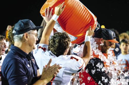 Shorthorns shower their head coach, Luke Hobbs, with a cooler full of ice following their win against Three Rivers Friday night. More on the game on Page B3 today. Photo by Andy Behlen