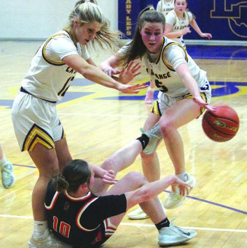 La Grange’s Ashtyn Smith, left, and Campbell Cooper, right force a turnover in Tuesday’s game. Photo by Jeff Wick