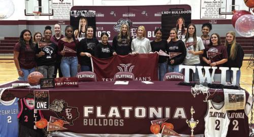 Summer Sodek, center in black, is joined by her teammates at her signing ceremony last week in Flatonia.