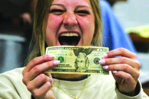 Senior Bailey Swisher reacts to finding a $20 bill in the letter she sent herself as an 8th grader. Photo by Meadow Taylor-Marklin