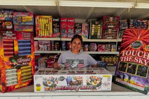 The Mr. B Fireworks stand on the Bluff south of La Grange opened Tuesday, June 30. Stand operator Blanca Villanueva is pictured above with some of the most spectacular fireworks bundles available for purchase. The America’s Finest package, in the center, features 108 shots for a price of $239. She called it “the most bang for your buck.” Photo by Andy Behlen