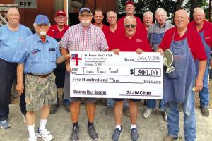 The St. James Men’s Club Holy Smokers recently cooked for the Fayette County Texas Ramp Project. Pictured second and fourth from left is John Marburger and Frank Smith of the Fayette County Texas Ramp Project surrounded by men of the Holy Smokers.