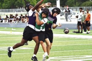 La Grange’s Skip Holmes, left, and Colt Jobb, right, break up this pass attempt versus Taylor Saturday. Photo by Darrell D. Gest