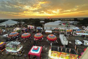 In this view from the top of the Ferris Wheel Thursday night, the sun sets over the Colorado River Valley on the first night of The Fayette County Fair in La Grange. Photo by Jeff Wick 