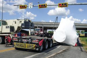 A big rig that turned from the Highway 71 Bypass north onto SH 159 lost its load near the 71 overpass in La Grange on Thursday. The load was a 75,000 lb. piece of air conditioning equipment, pictured above wrapped in white plastic. Photo by Andy Behlen