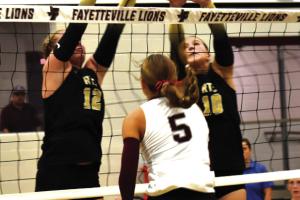 Round Top-Carmine’s Madison Markwardt, left, and Rebekah Sacks, right, jump to try to block this hit by Fayetteville’s Cambree Denham the first time these two district rivals met back on Oct. 13. These state-ranked foes face one another again this Friday at 6 p.m. in Carmine in the regular season finale. Photo by Paul Kipp