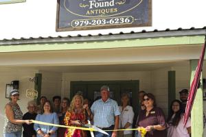 Aribbon cutting for the new antique shop in Carmine, Forgotten and Found Antiques was held Oct. 3 hosted by the Carmine Chamber of Commerce. Pictured are owners Christine and Stephen Rosenbaum (center.) Diane Tovey and Marlene Waak are holding the ribbon. Other members of the Carmine Chamber of Commerce are pictured in the background.